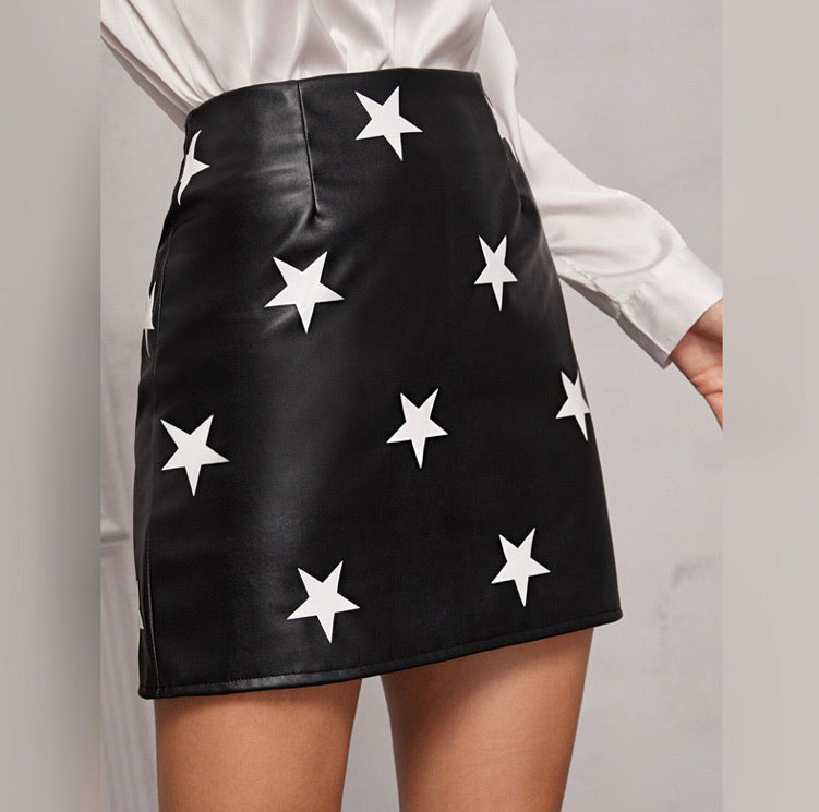 black faux leather skirt with whit stars.  Above the knee length